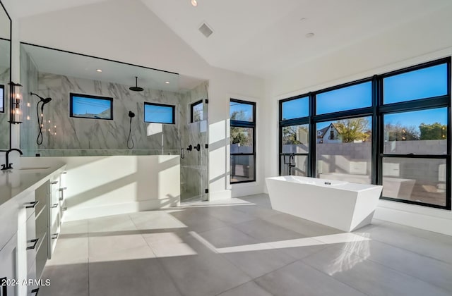 bathroom featuring high vaulted ceiling, visible vents, vanity, a freestanding bath, and a marble finish shower