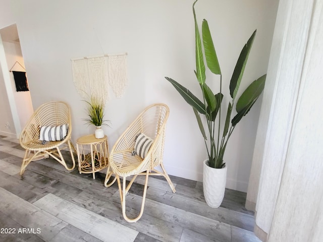 sitting room featuring baseboards and wood finished floors