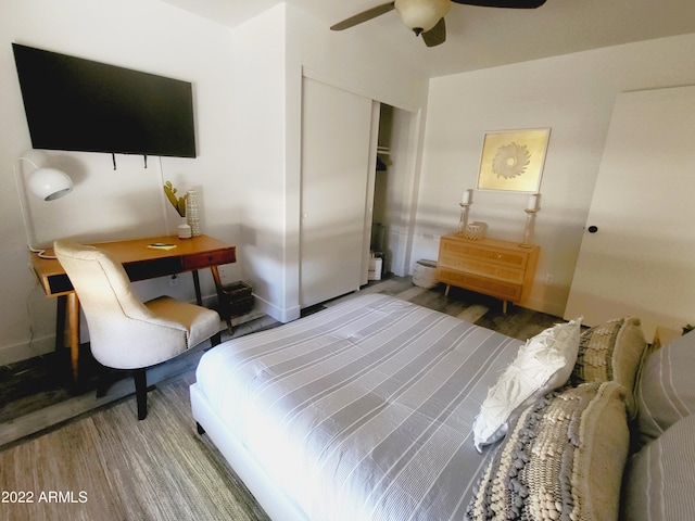 bedroom with a closet, ceiling fan, baseboards, and wood finished floors