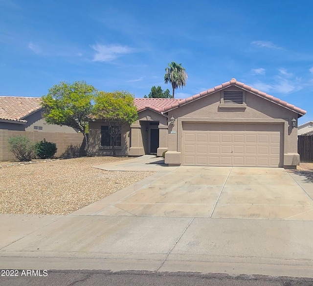 single story home with a tile roof, fence, concrete driveway, and stucco siding