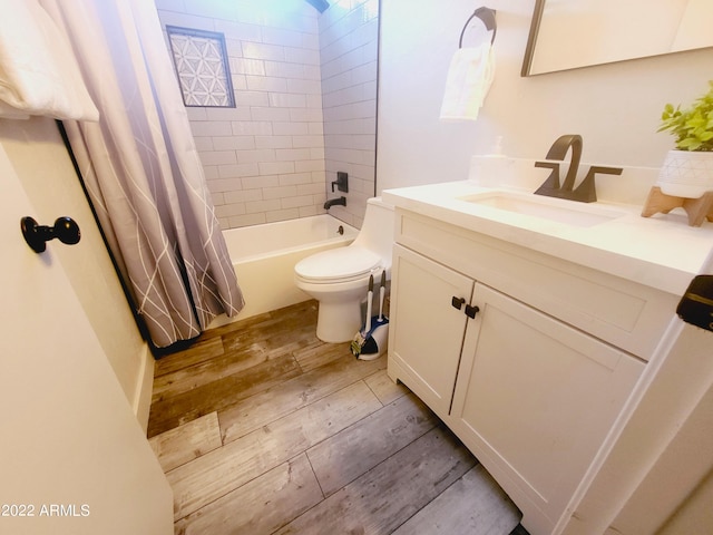 full bathroom featuring toilet, shower / bathtub combination with curtain, wood finished floors, and vanity