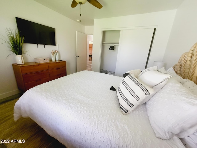 bedroom with a closet, ceiling fan, baseboards, and wood finished floors