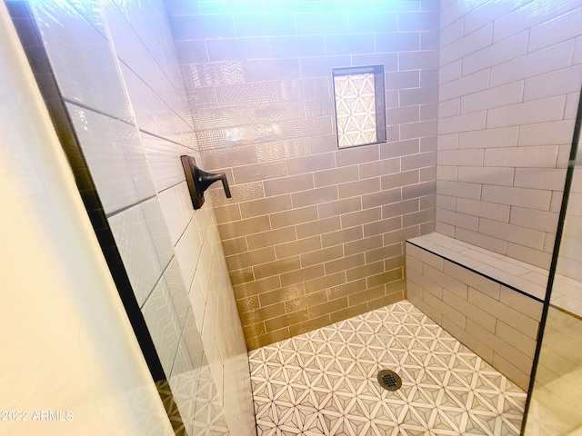 full bath featuring a tile shower