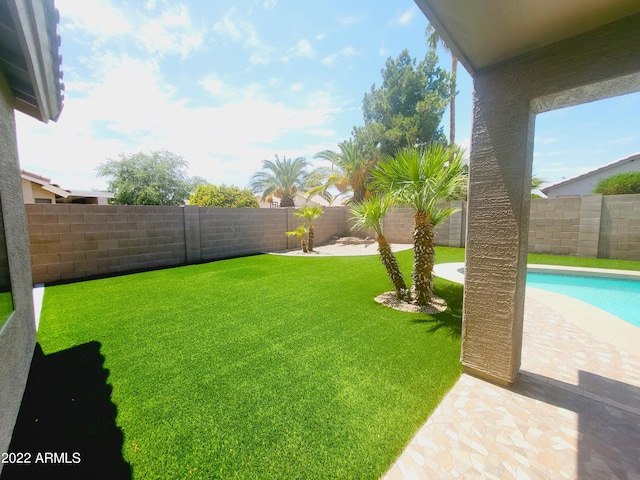 view of yard featuring a fenced in pool and a fenced backyard