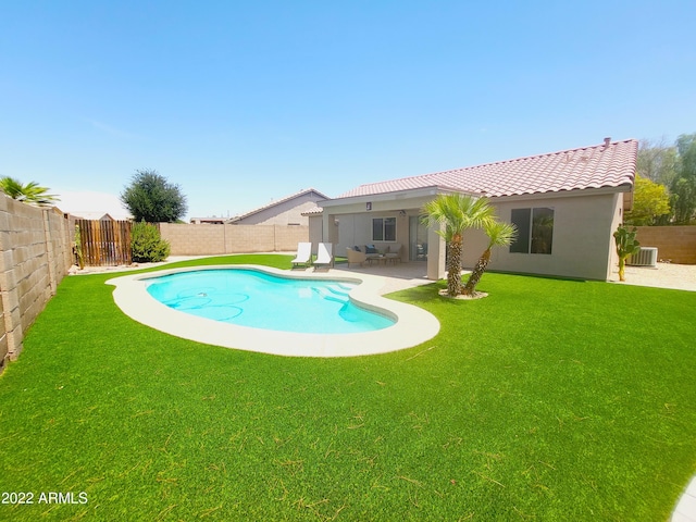 view of swimming pool with a fenced in pool, a patio, a fenced backyard, a yard, and central AC