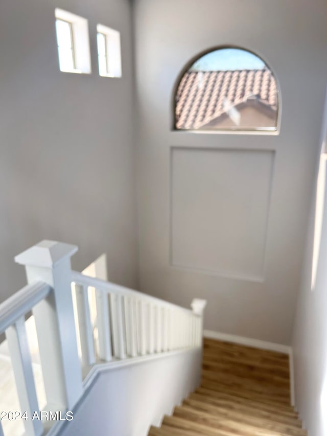 stairs with hardwood / wood-style floors