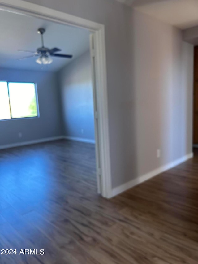 unfurnished room featuring ceiling fan and dark hardwood / wood-style flooring