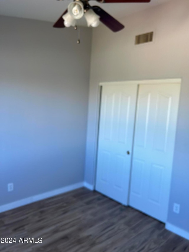 unfurnished bedroom with ceiling fan and dark hardwood / wood-style floors