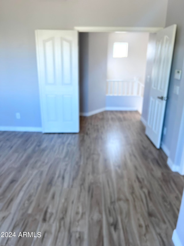 empty room with dark hardwood / wood-style flooring