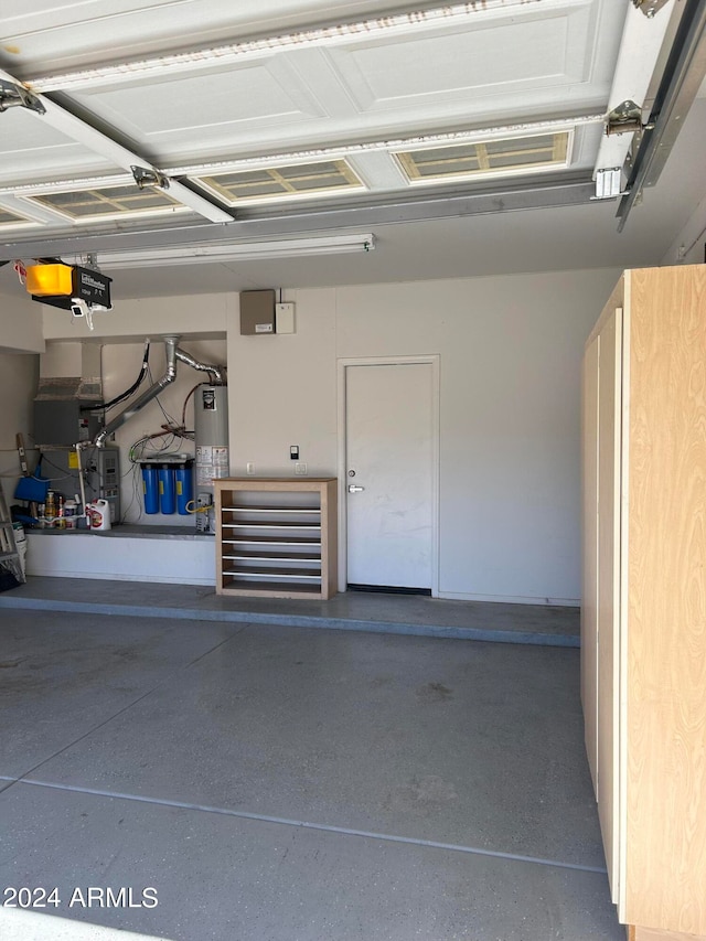 garage with a garage door opener and water heater