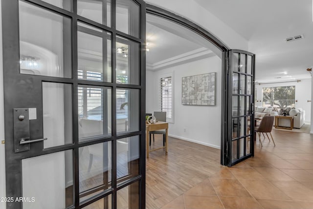 hall with tile patterned flooring, french doors, visible vents, and baseboards