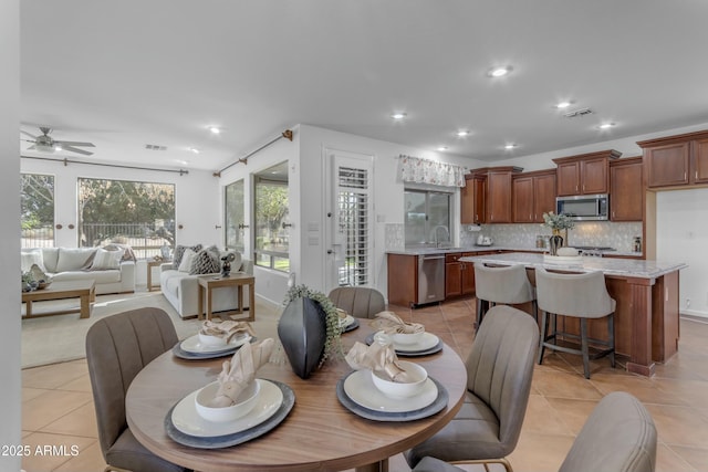 dining room with light tile patterned floors, ceiling fan, visible vents, and recessed lighting