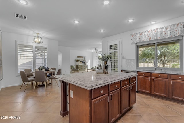 kitchen featuring light tile patterned floors, recessed lighting, visible vents, and light stone countertops