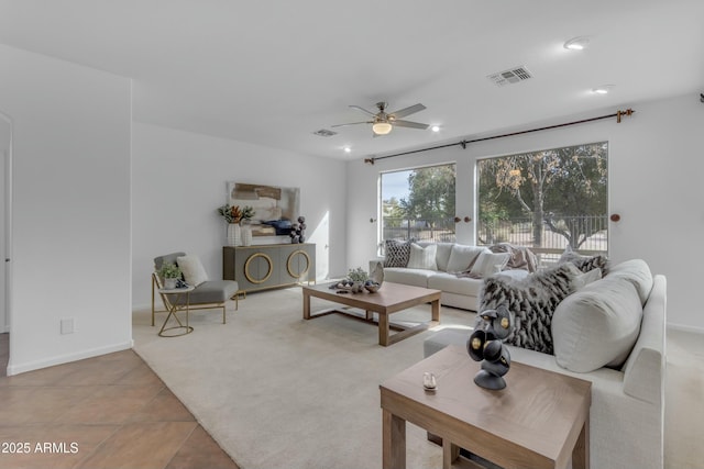 tiled living area featuring carpet, baseboards, visible vents, and a ceiling fan