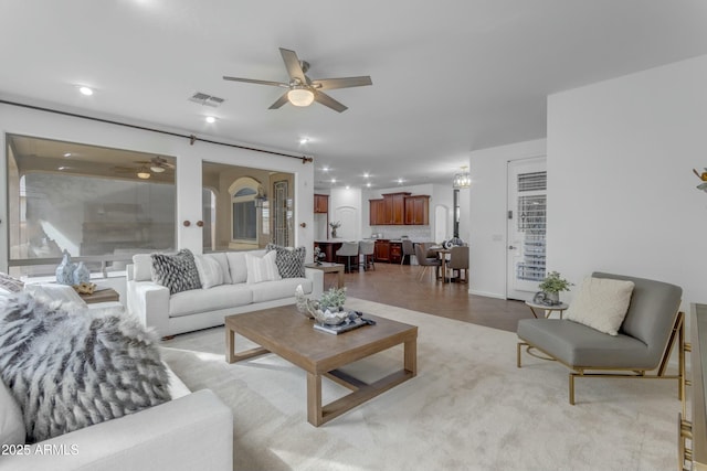 living area featuring ceiling fan, visible vents, and recessed lighting