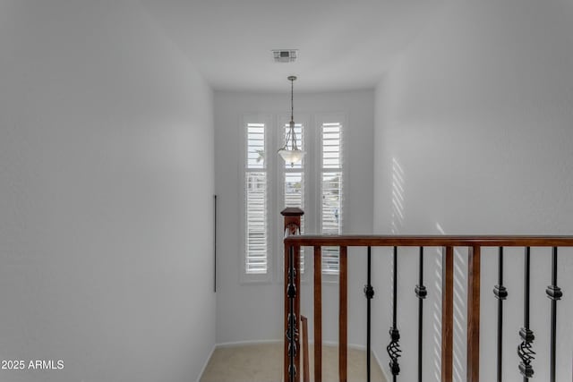 staircase featuring carpet floors and visible vents