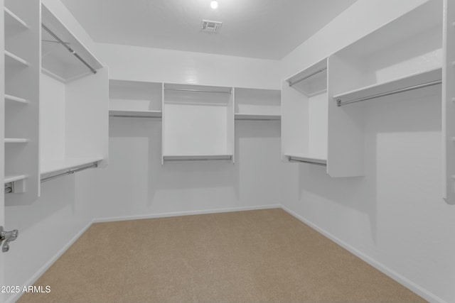 spacious closet featuring light carpet and visible vents