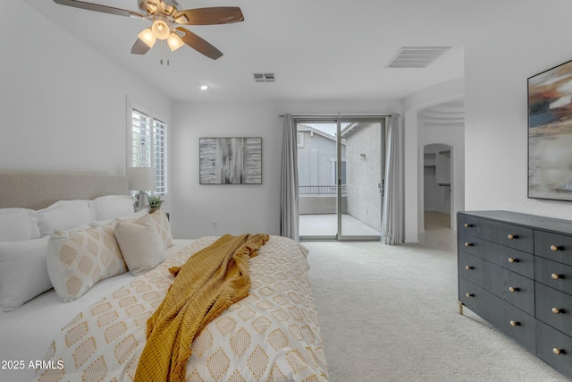 bedroom featuring access to outside, visible vents, arched walkways, and light colored carpet