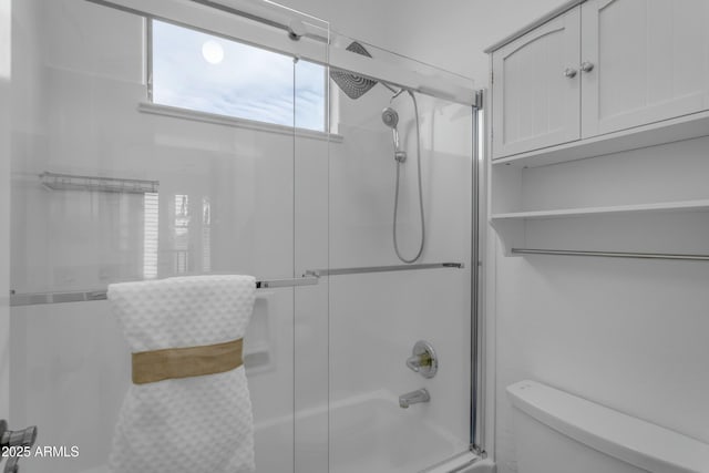 bathroom with toilet and enclosed tub / shower combo