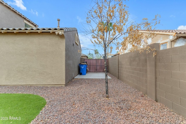 view of yard featuring fence and a gate