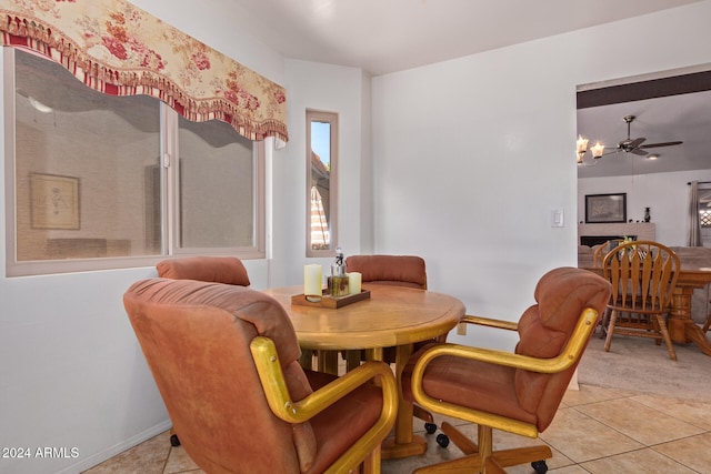 tiled dining space featuring ceiling fan