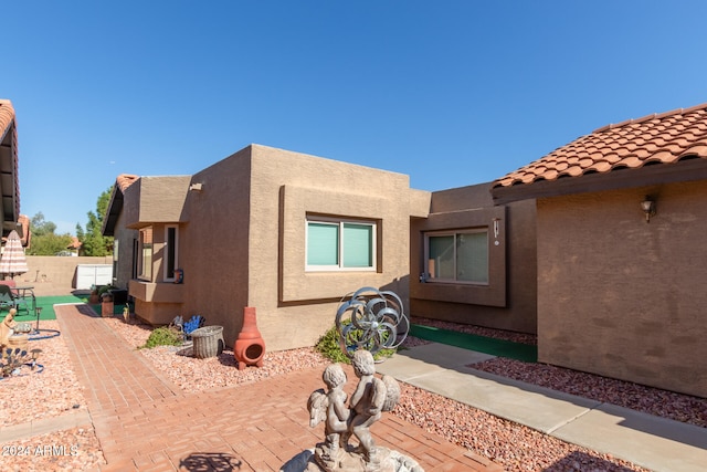 view of side of home featuring a patio area