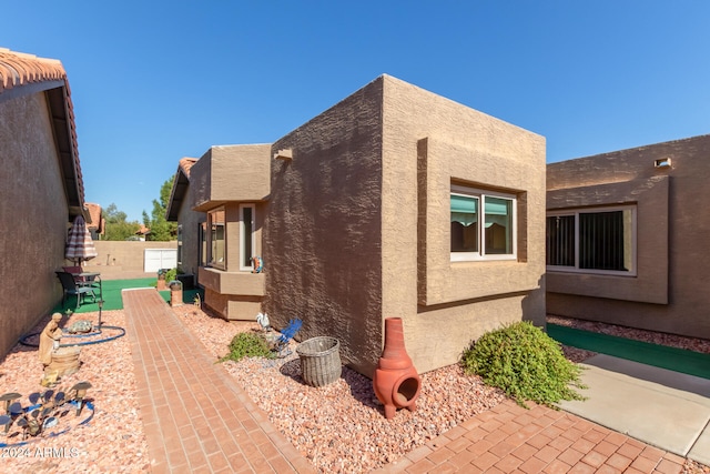 view of side of home with a patio area