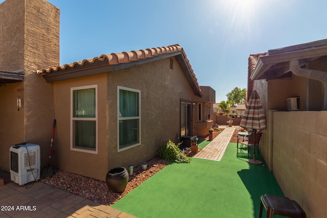 view of side of property with a patio