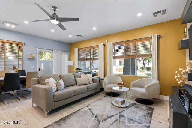 living area featuring recessed lighting, visible vents, and light wood finished floors