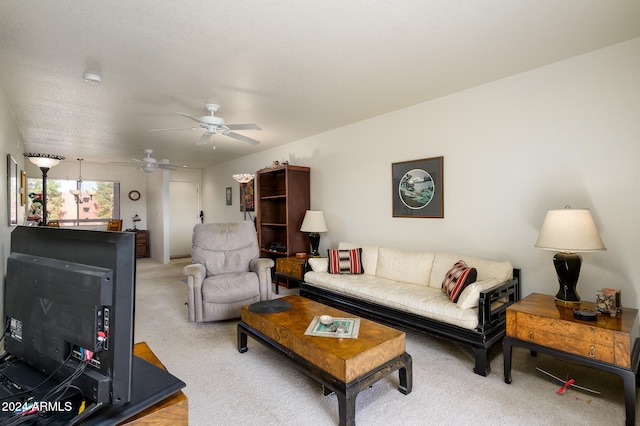 carpeted living room with ceiling fan and a textured ceiling