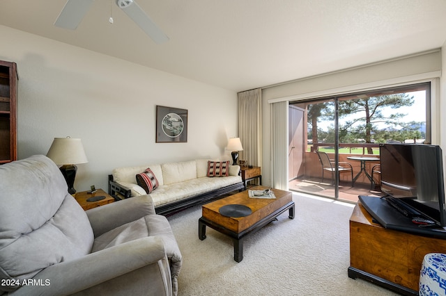 carpeted living room featuring ceiling fan