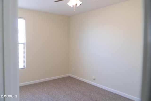 unfurnished room with light colored carpet and ceiling fan