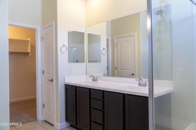 bathroom featuring vanity, a shower with shower door, and tile patterned floors