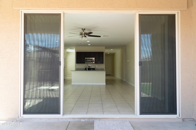 doorway to property featuring ceiling fan