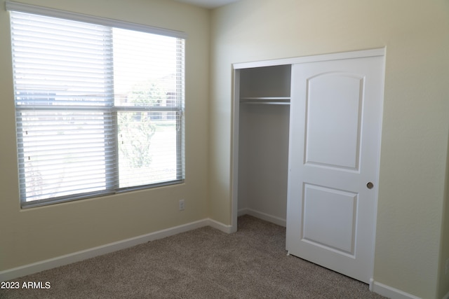 unfurnished bedroom featuring a closet and carpet