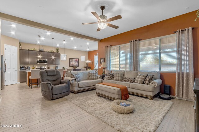 living room featuring light hardwood / wood-style floors and ceiling fan