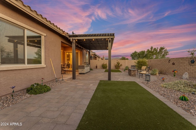 yard at dusk with a pergola and a patio area