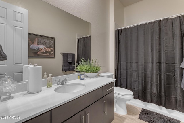 bathroom featuring wood-type flooring, vanity, and toilet