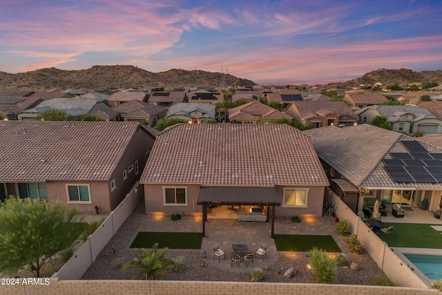 aerial view at dusk featuring a mountain view