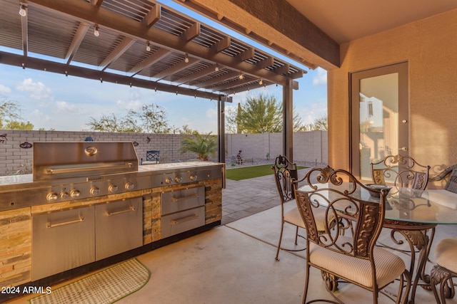 view of patio / terrace with area for grilling, an outdoor kitchen, and a pergola