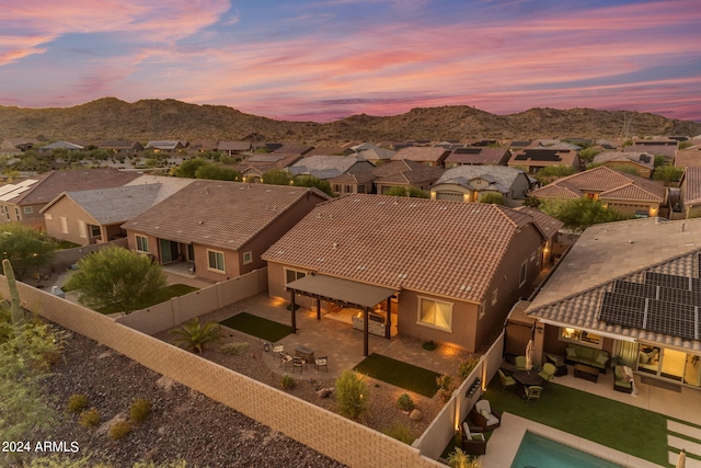 aerial view at dusk featuring a mountain view