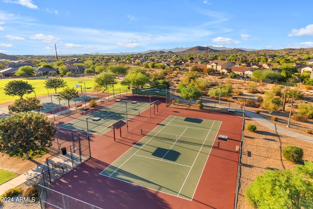 view of tennis court featuring a mountain view