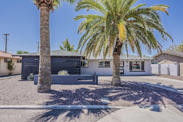 8137 E Indian School Rd, Scottsdale, AZ 85251 - view of front of home featuring stucco siding and roof with shingles
