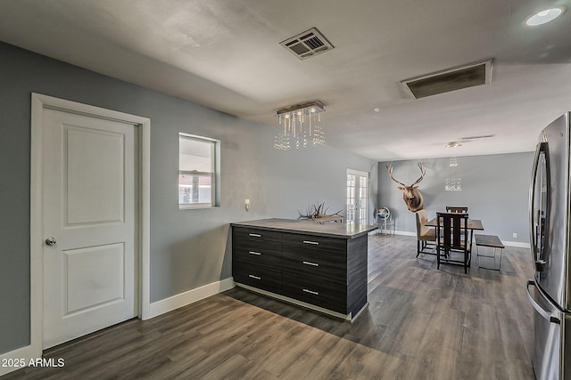 8137 E Indian School Rd, Scottsdale, AZ 85251 - kitchen with freestanding refrigerator, dark wood-style flooring, a peninsula, and dark cabinets