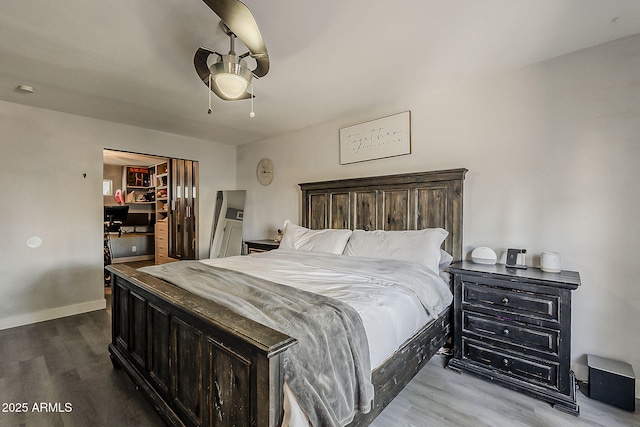 8137 E Indian School Rd, Scottsdale, AZ 85251 - bedroom featuring dark wood-style flooring, a ceiling fan, a closet, and a spacious closet