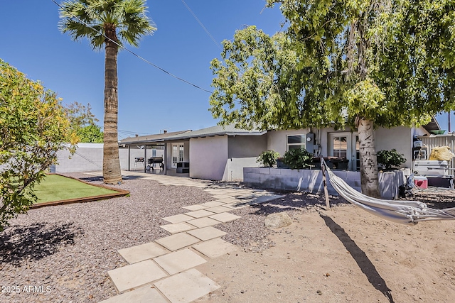 8137 E Indian School Rd, Scottsdale, AZ 85251 - rear view of house with stucco siding and a patio