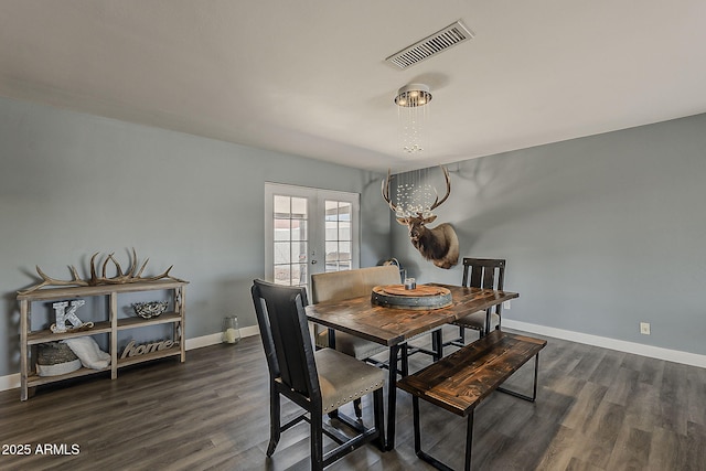 8137 E Indian School Rd, Scottsdale, AZ 85251 - dining space featuring dark wood-type flooring and a chandelier