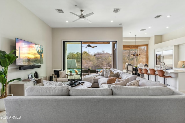 living room featuring sink and ceiling fan