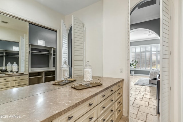 bathroom featuring crown molding and vanity