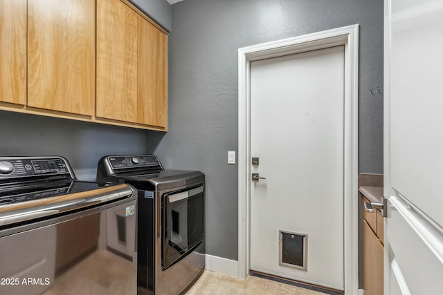 laundry room with cabinets and separate washer and dryer